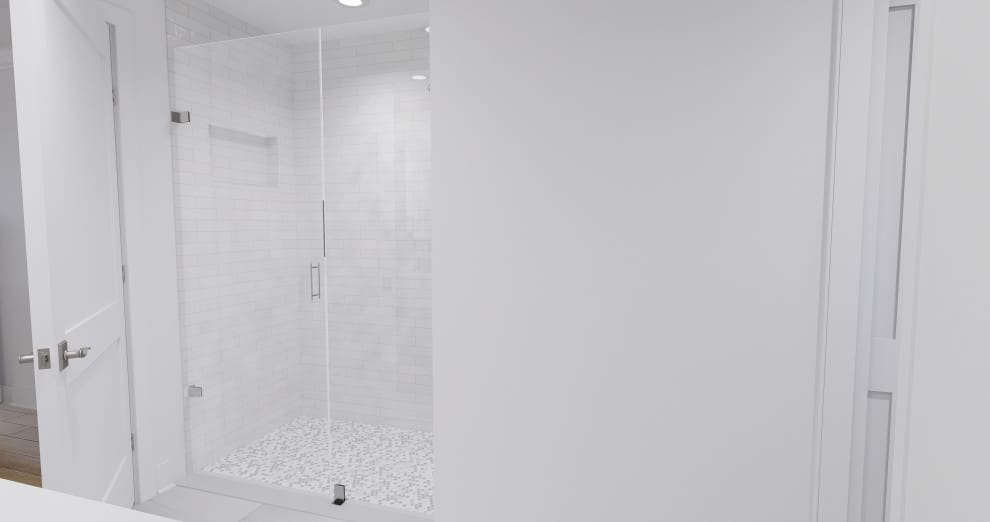 A white bathroom with a glass shower door.