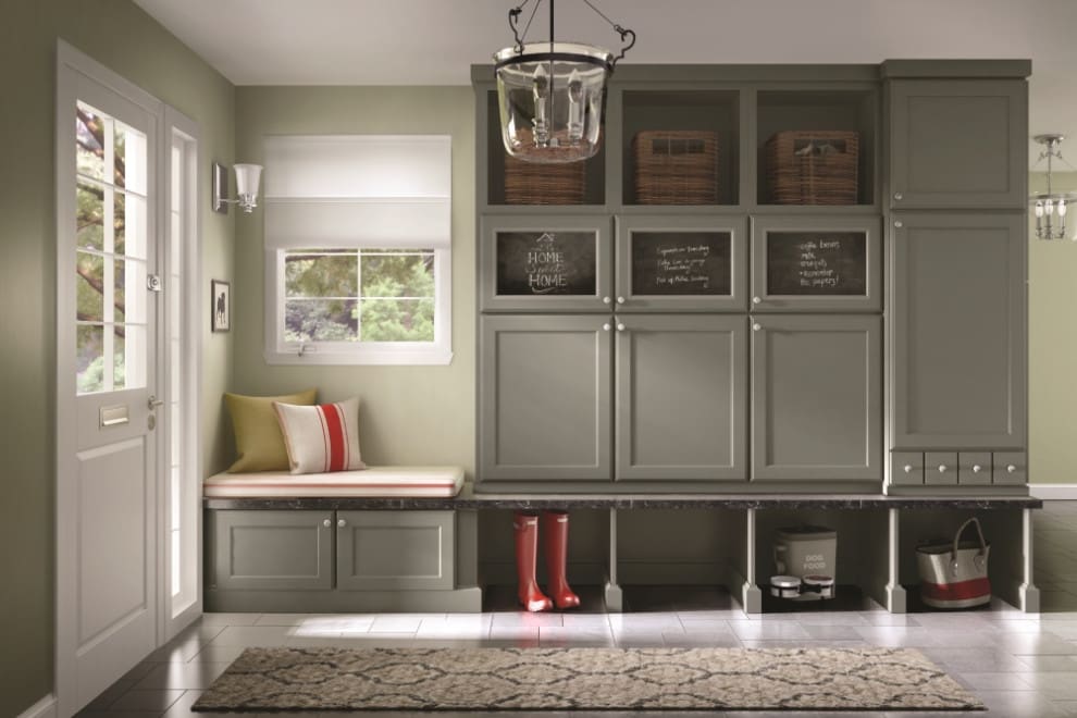 A room with a bench and cabinets in it